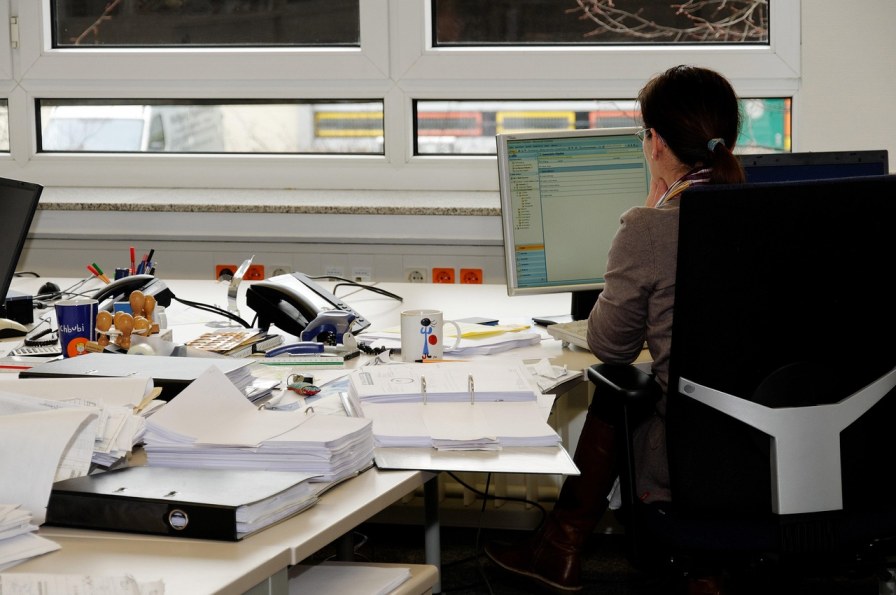 Accountant reviewing client files during a CDD refresh
