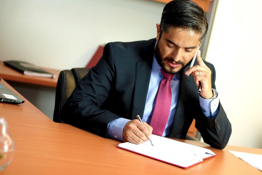 Accountancy professional reviewing paperwork while preparing for FCA AML registration and supervision changes