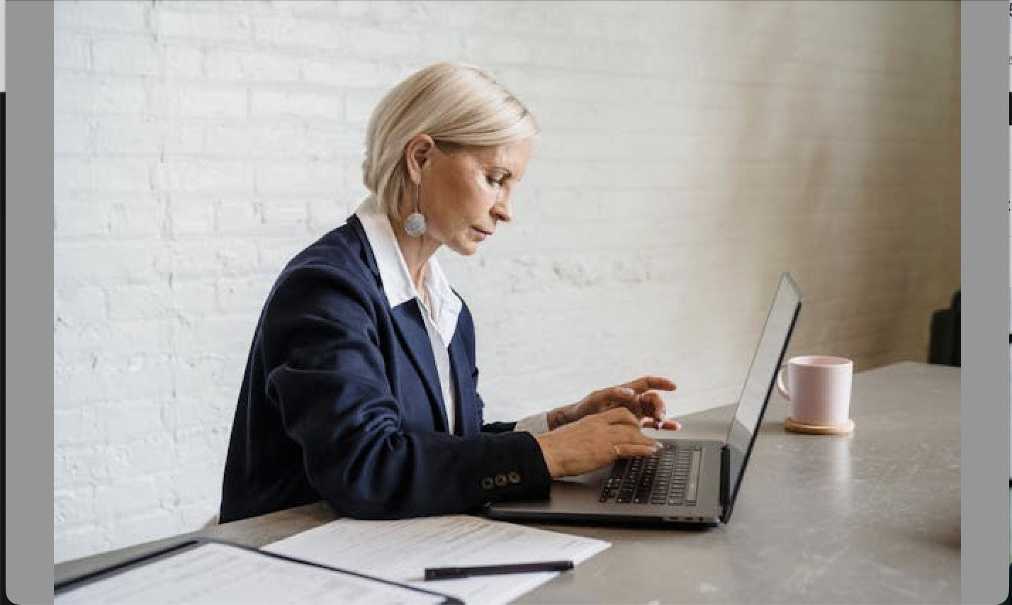 Professional reading AML compliance updates on a laptop