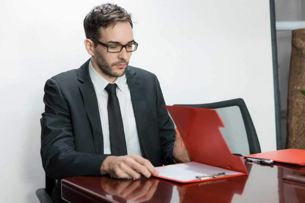Accountant reviewing client files for geographic AML risk in a firm-wide assessment.