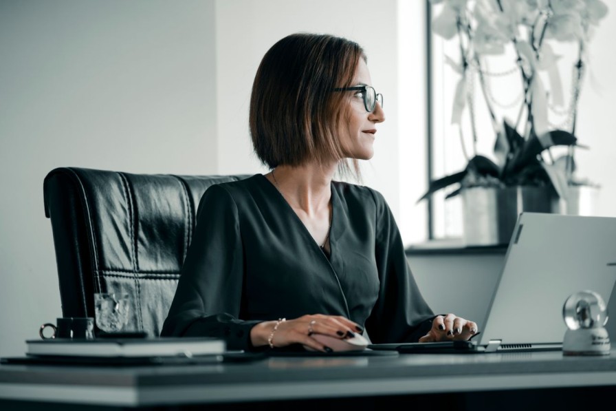Professional working at a laptop in an office, representing AML risk assessment and firm-wide compliance review for accountancy firms.