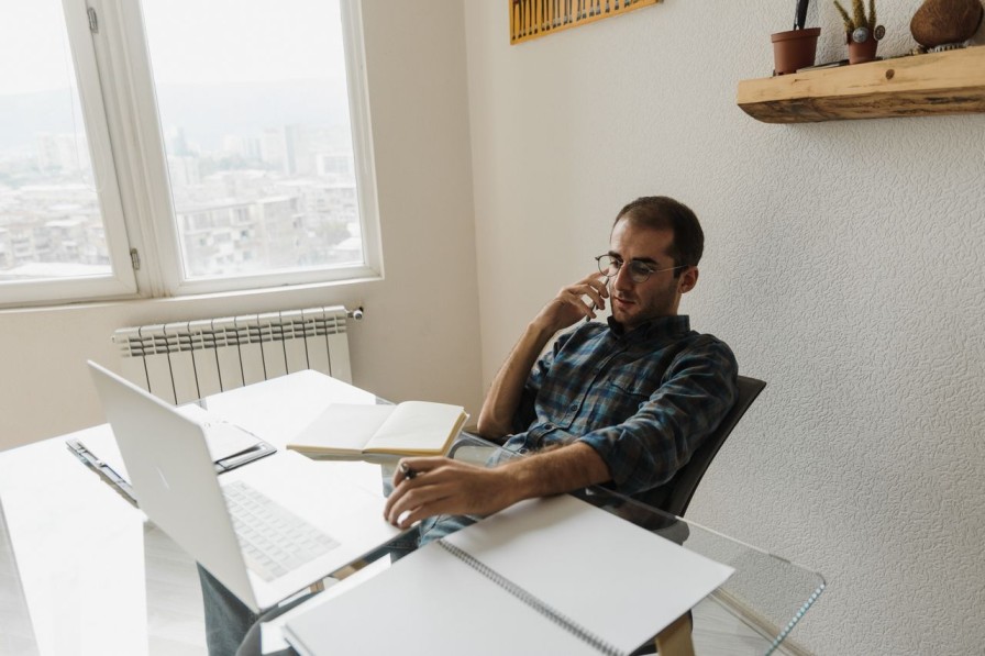 Professional reviewing documents at a desk, representing independent AML audit and review work in a small accountancy firm.