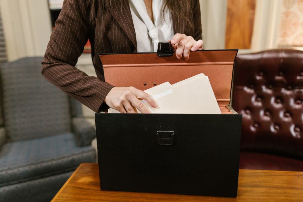 Accountancy firm staff placing client files into secure storage for confidential SAR record keeping