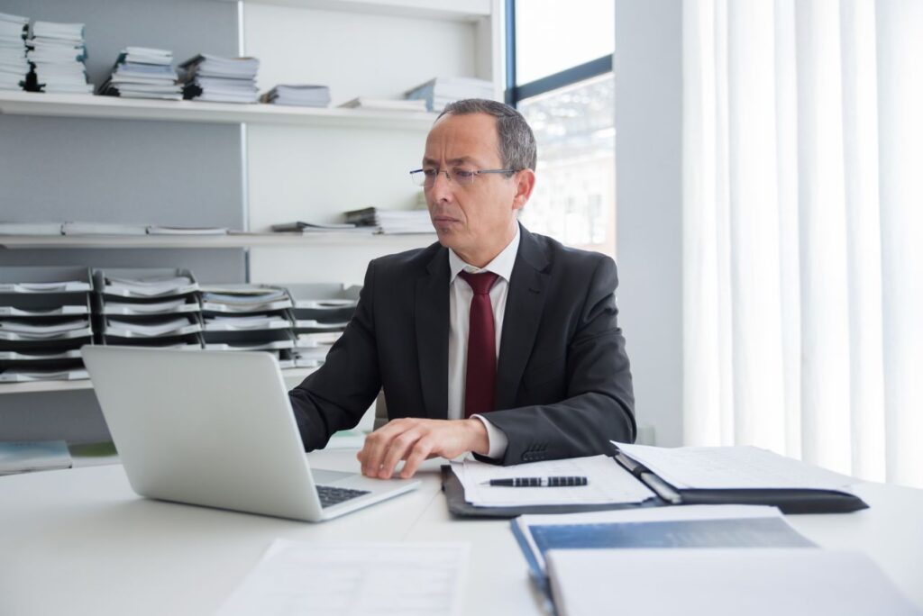 Senior accountancy professional reviewing AML responsibilities and compliance records