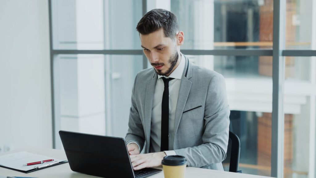 Accountancy firm preparing a suspicious activity report on a laptop.