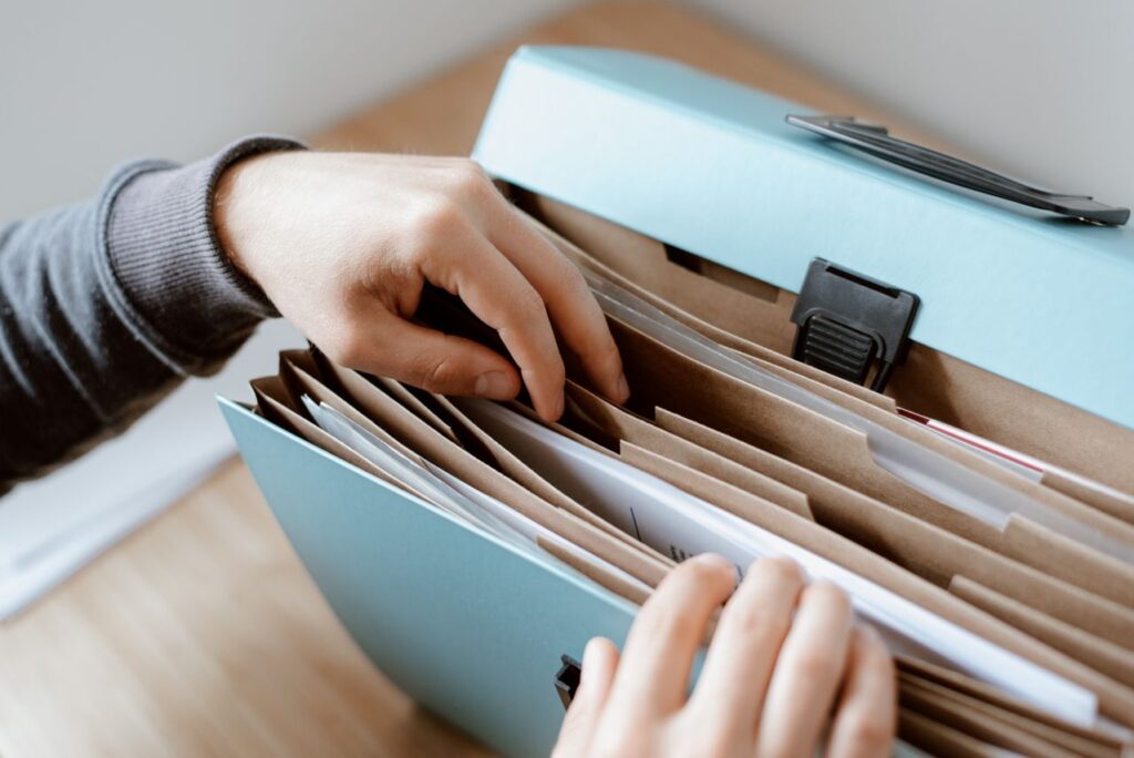 Accountancy firm staff member organising AML records and client files