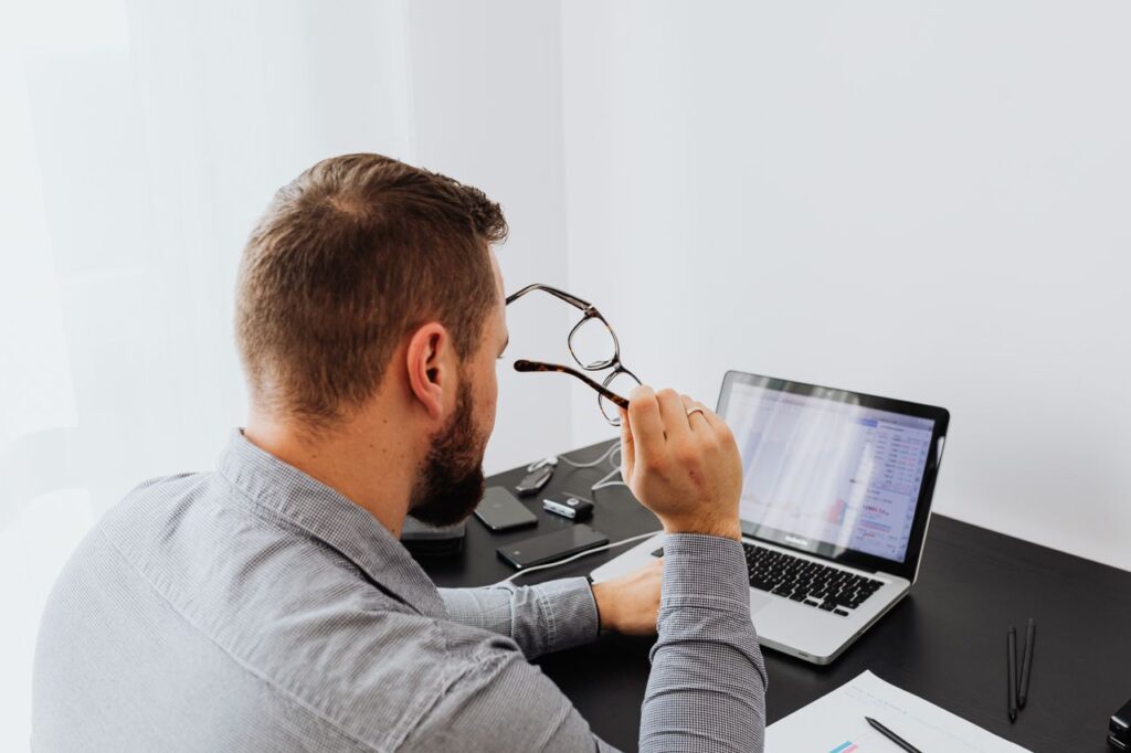 Accountant reviewing information on a laptop as part of AML supervision and compliance